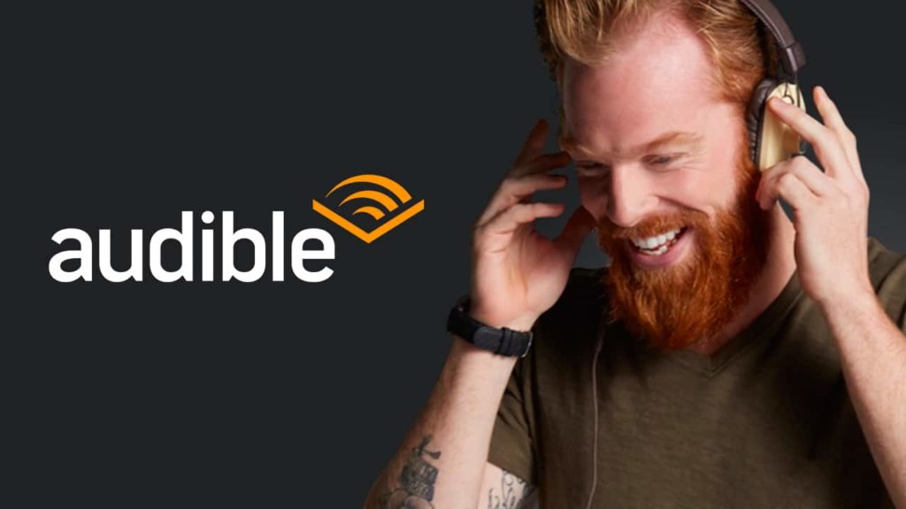 Man listening to an audible audio book. He just scored a great deal on this audible book from Audible's Black Friday sales event