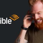 Man listening to an audible audio book. He just scored a great deal on this audible book from Audible's Black Friday sales event