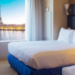 Hotel room in Paris looking out at Eifel Tower booked using Priceline Black Friday discounts